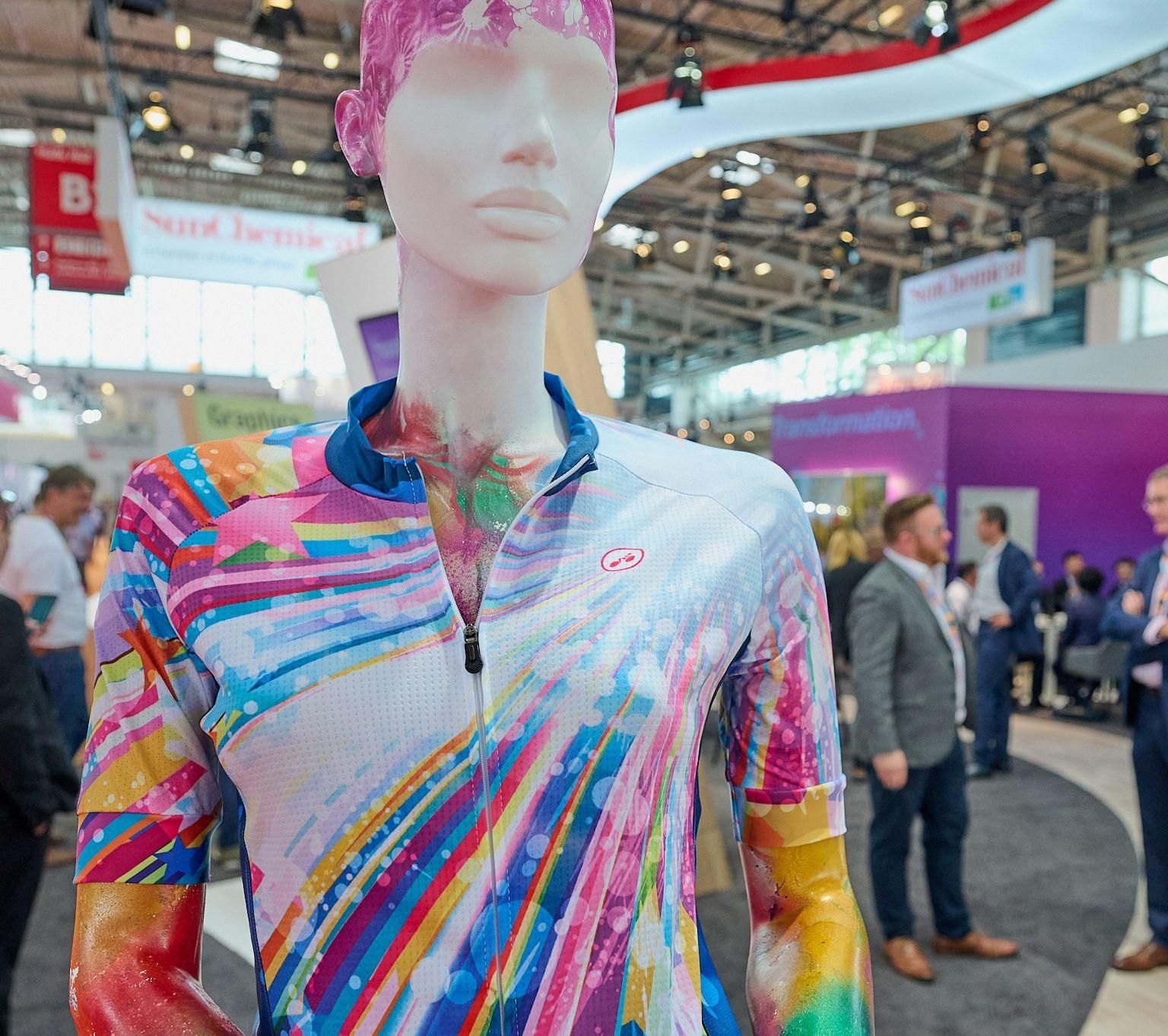 Mannequin wearing a colourful printed sports top on an exhibition stand